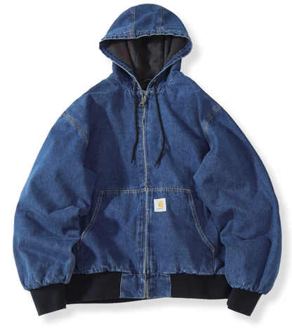 A blue denim Carhartt hooded jacket with black ribbed cuffs and hem, displayed flat against a white background.